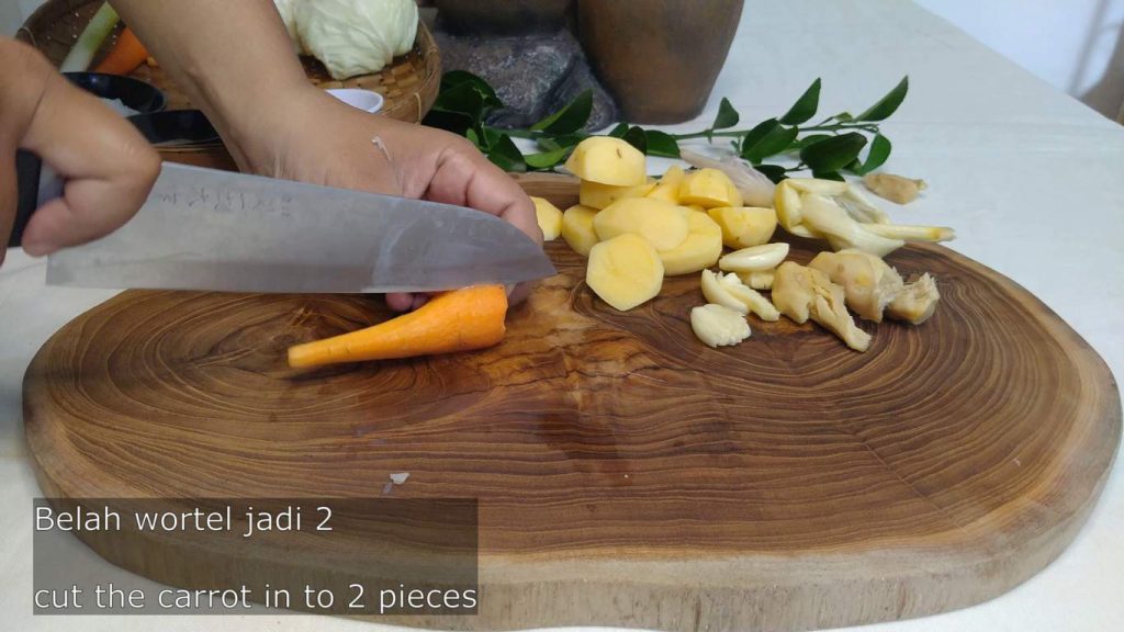 cutting carrots for a healthy homemade chicken soup
